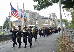 A Quincy police color guard leads a contingent of officers and the family of the late Quincy police officer Alfred Hollis at St. Mary's Cemetery in Quincy for the dedication of a headstone for the late officer, who was killed in the line of duty in 1927, Saturday, Oct. 1, 2022.