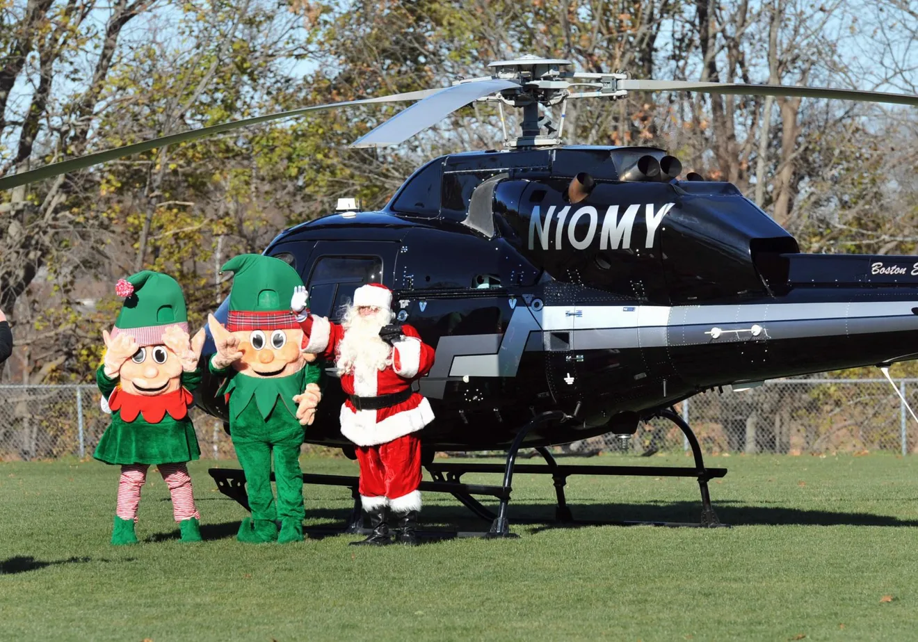 Santa Claus arrives with his elves as hundreds of spectators greet them at Pageant Field in Quincy, on Saturday, Nov. 26, 2022.