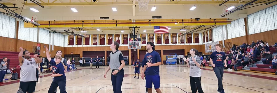 Weymouth player Vinny Marques, left, scores for the Wildcats as the Weymouth High Unified Basketball team hosts Walpole